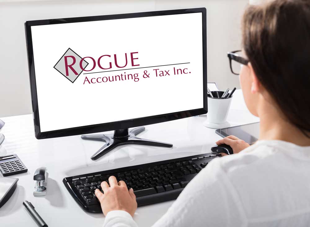 Woman at computer with Rogue Accounting and tax logo